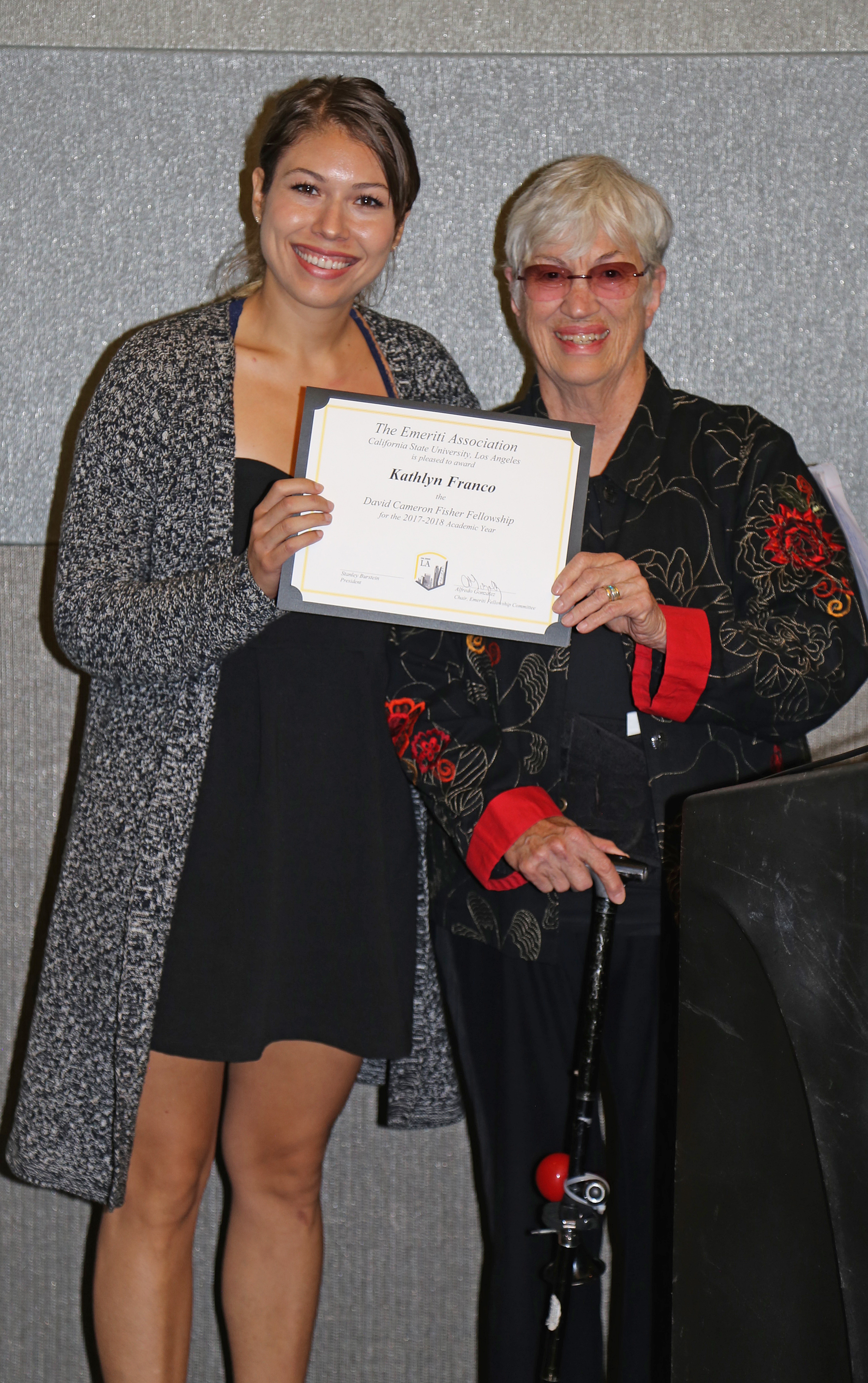 Katelun Franco and professor at podium at fall 2017 luncheon