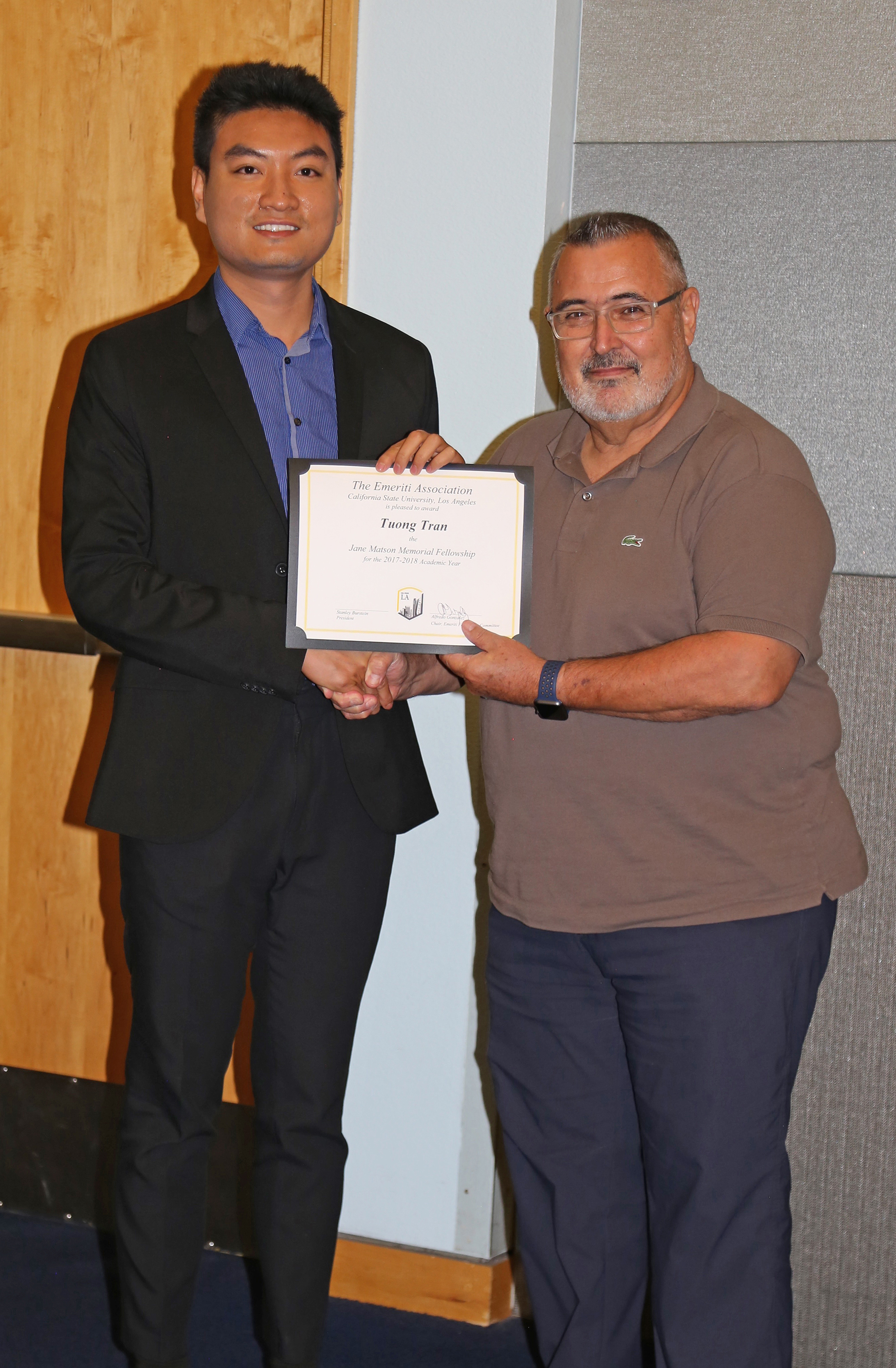 Tuong Tran and professor at podium at fall 2017 luncheon