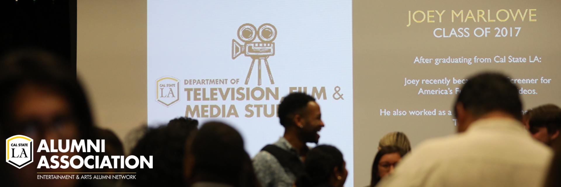 Room of people talking in front of a projector with text that reads Department of Television, Film, and Media Studies