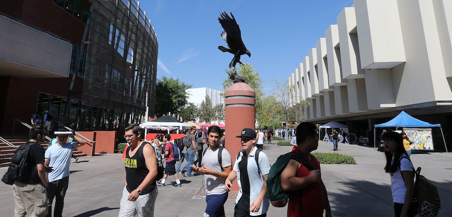 Students walk past Golden Eagle statue