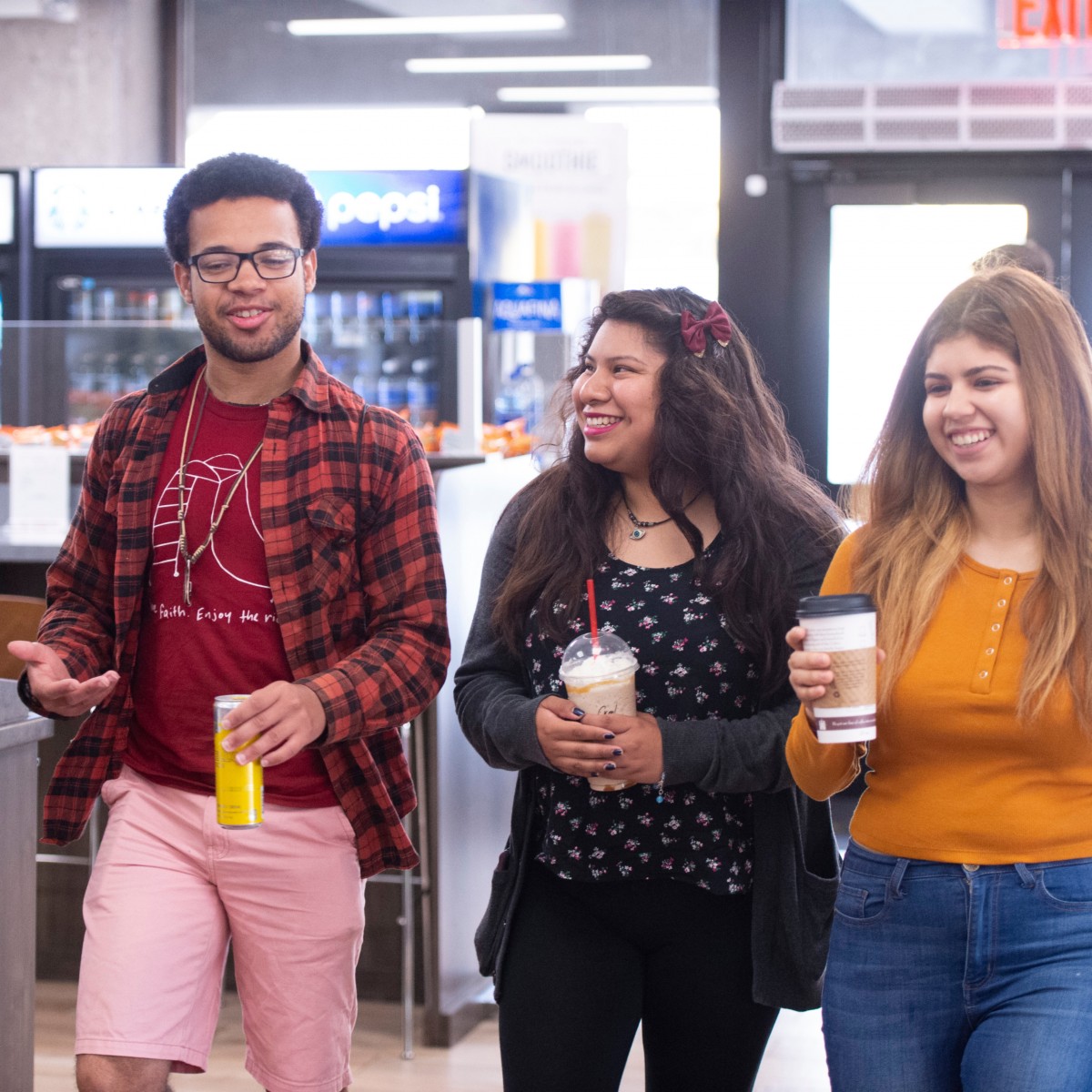 Students coming out of Cafe with drinks