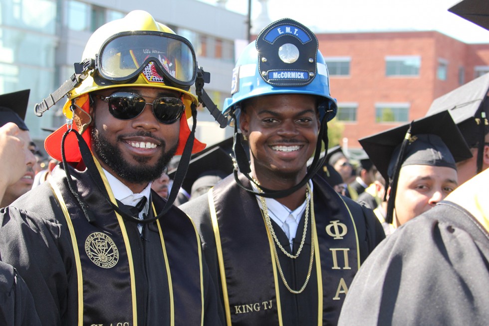 Fire Protection graduates wearing gowns and helmets at Commencement