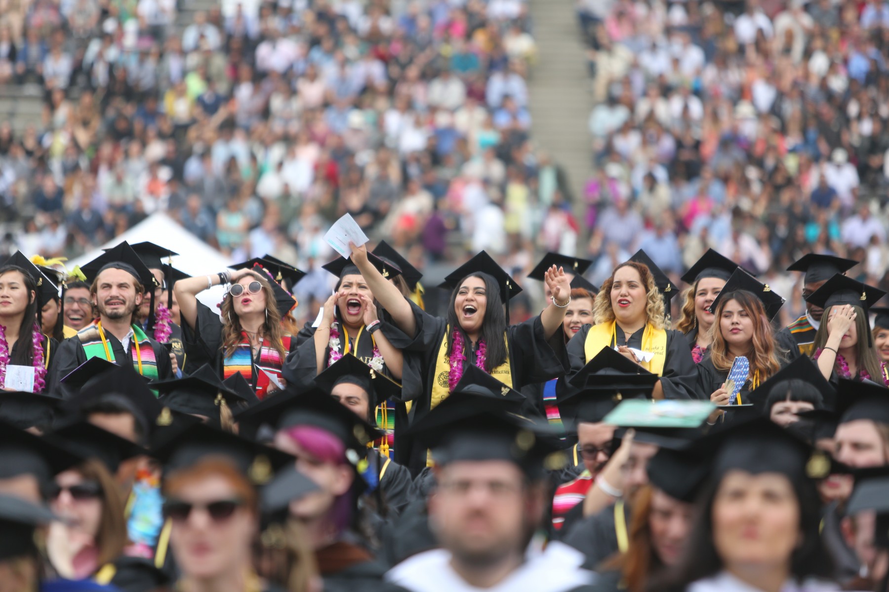 Student cheering at comencement