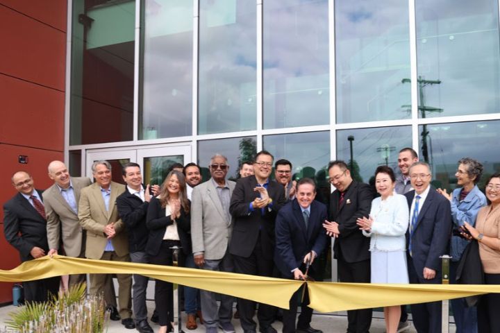 county officials and staff pose for ribbon ceremony 