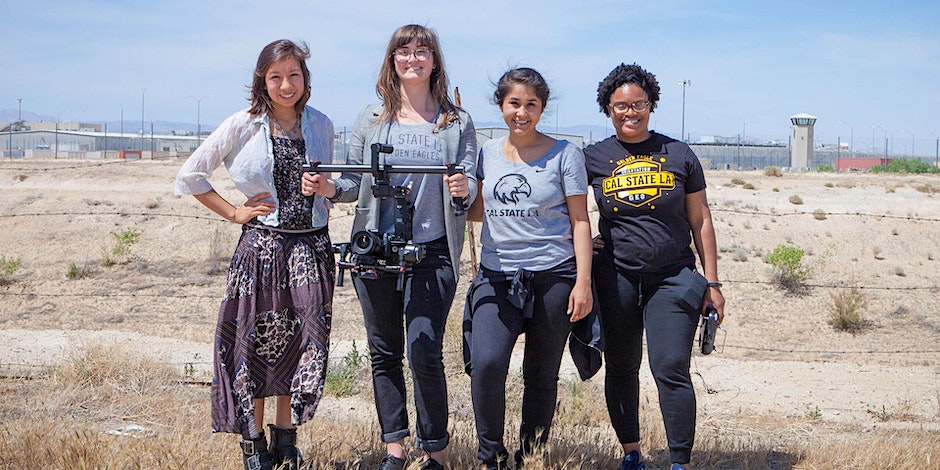 Photo: Heather Fipps Description: four Cal State LA students with cameras filming in the desert