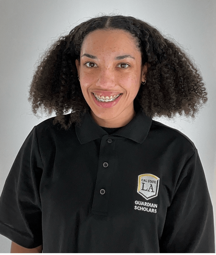 Kely Taylor, a peer mentor at Cal State LA, smiling and wearing a black Cal State LA Guardian Scholars polo shirt