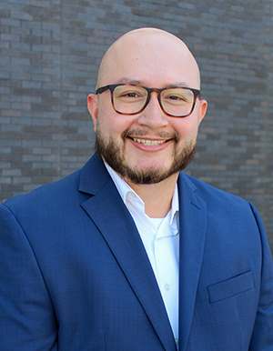 Person wearing glasses and smiling.