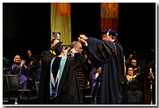 CSU Chancellor Timothy White places the Presidential Medallion upon the head of President William A. Covino.