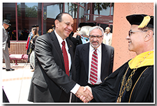 President William A. Covino accepts well-wishes from alumnus Willie Zuniga after the Investiture.