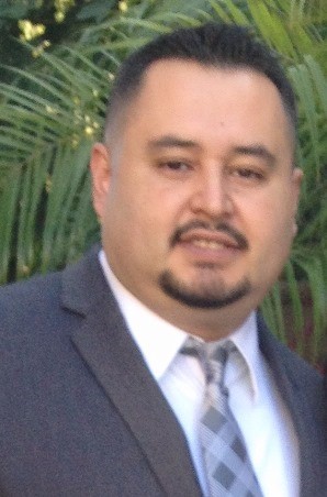 Jose, smiling and wearing business suit