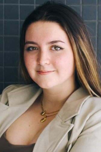 Student Katherine Bonomo wearing a tan blazer and black top.