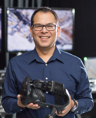 David Krum, holding a virtual reality display.