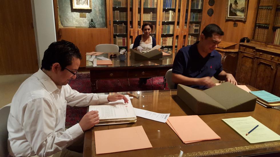 Members of the McGrath Working Group review archive materials