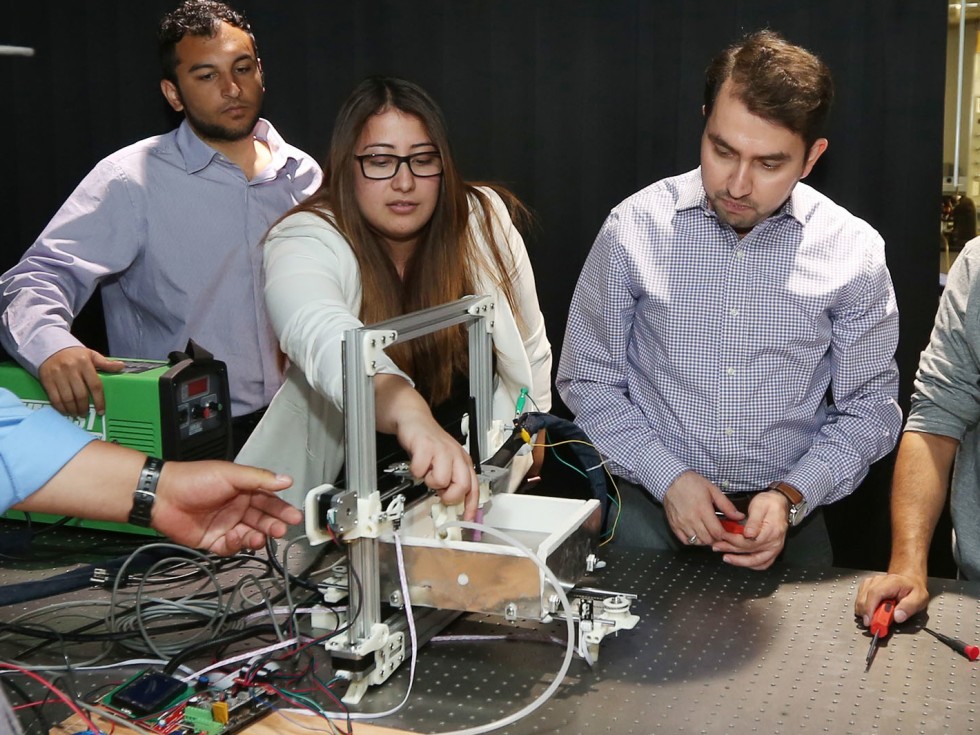 People working with a machine in a lab