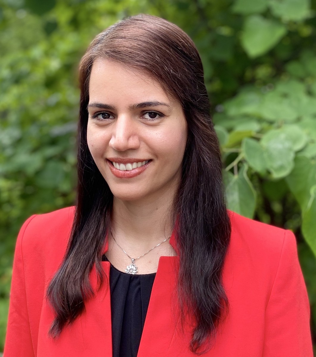 Negin Forouzesh, Ph.D. a female faculty with long hair in red jacket