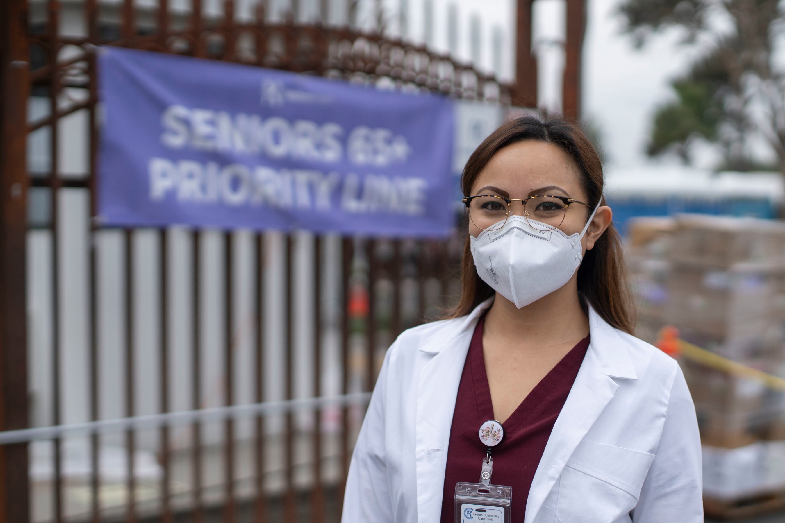 Nurse in mask and white coat outside clinic