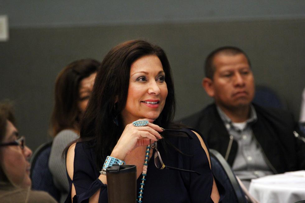 A mom smiling as she attends a Cal State LA parent program.