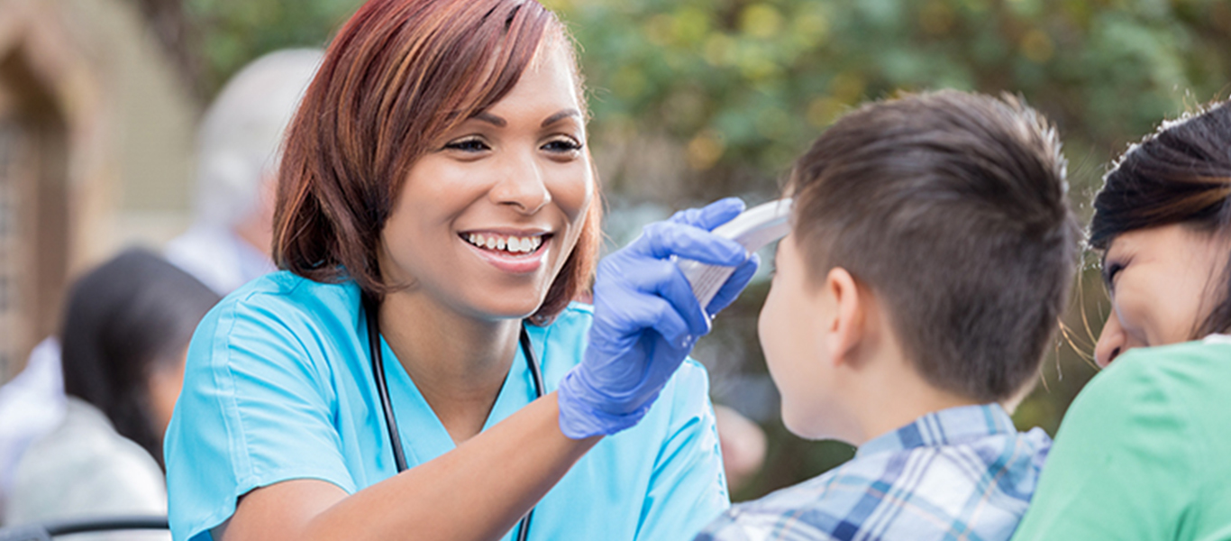 Student gives a community member a check up.