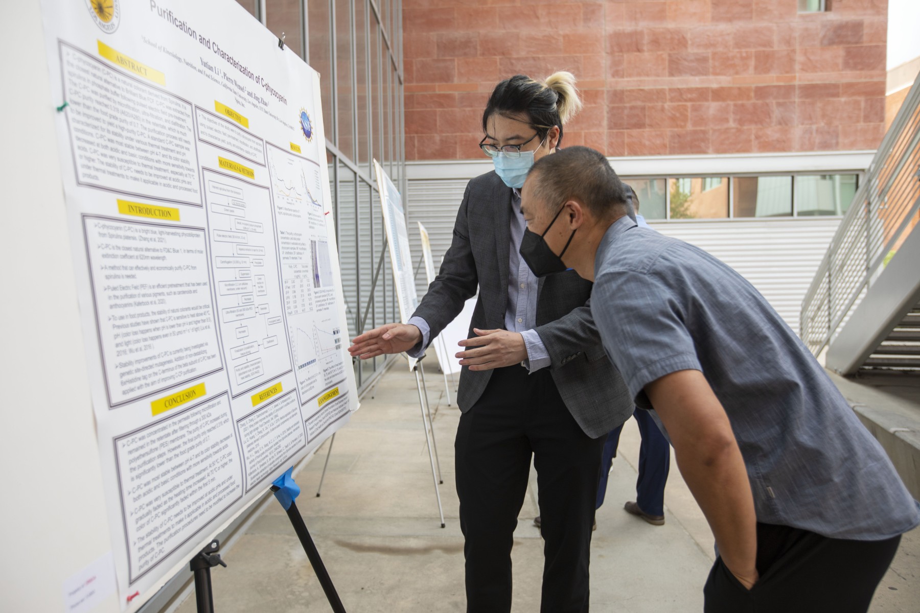 Student displaying research project to prospective student
