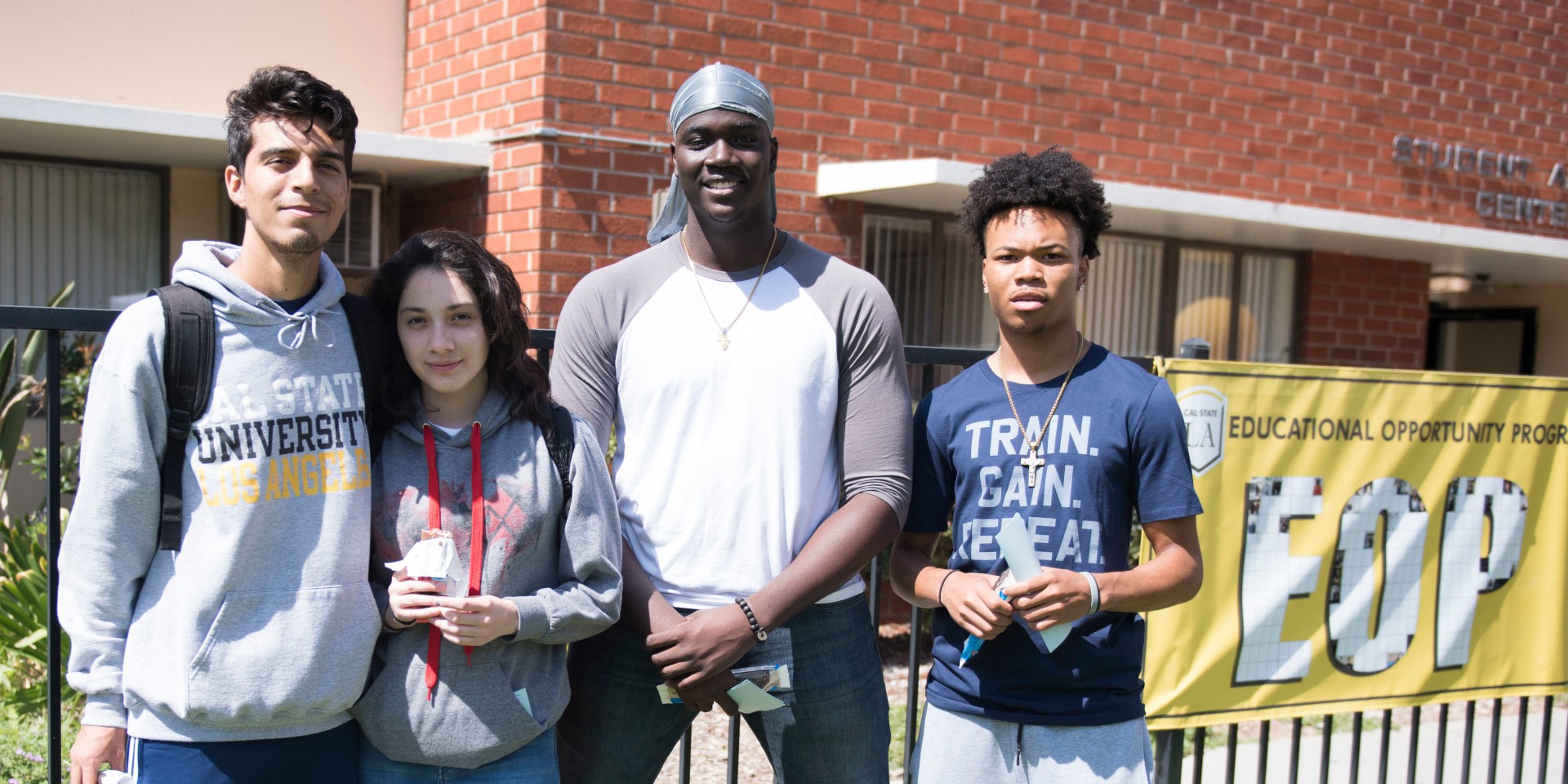 Students standing outside next to an EOP banner.