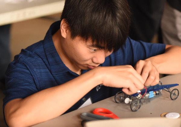 boy focuses on building a car kit