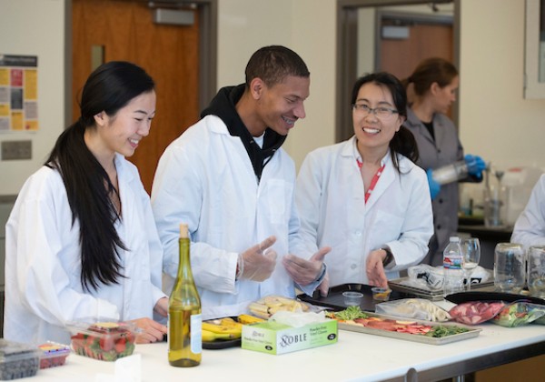 Professor and students working in a lab