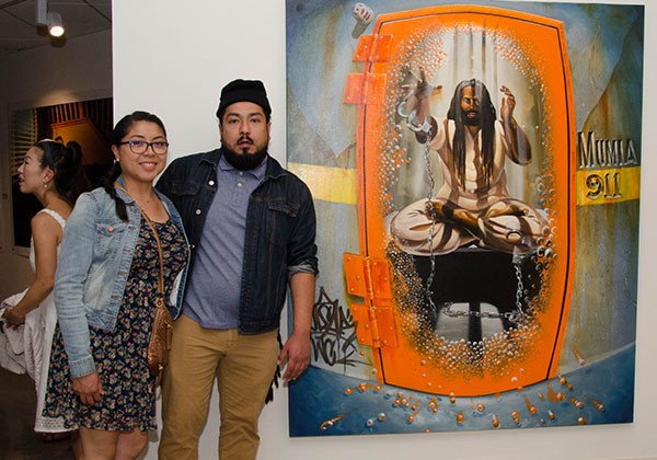 Atendees standing in front of artwork