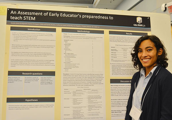 Student in front of research posterboard