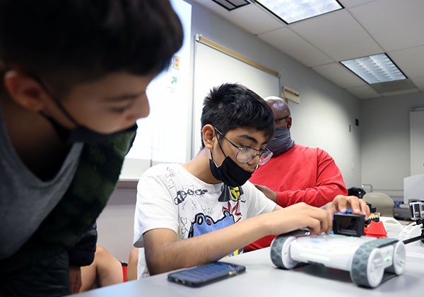 two students working on robotics