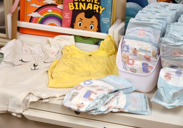 Disposable diapers, children's books on a table.
