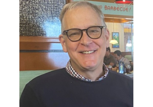 Professor Ellwanger wearing dark blue sweater and smiling