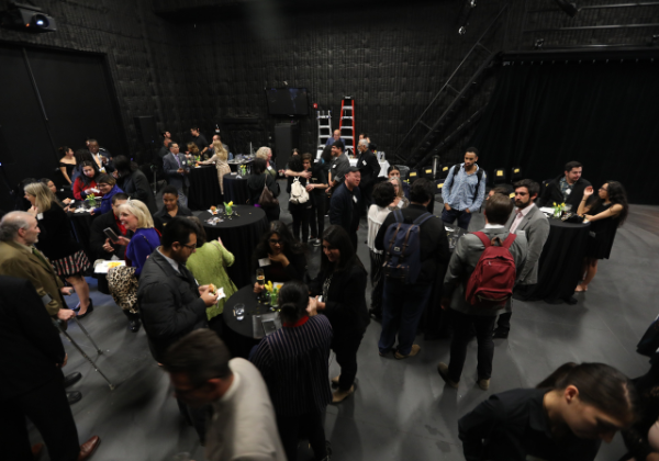 Large group of people socializing in a studio