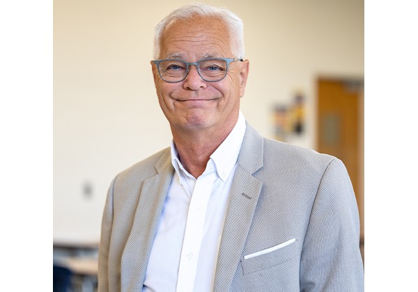 Professor Frecknall wearing a gray suit