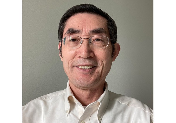 Professor Hu wearing a white dress shirt
