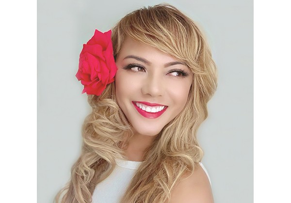 Lani with a red in her hair standing in front of a white background