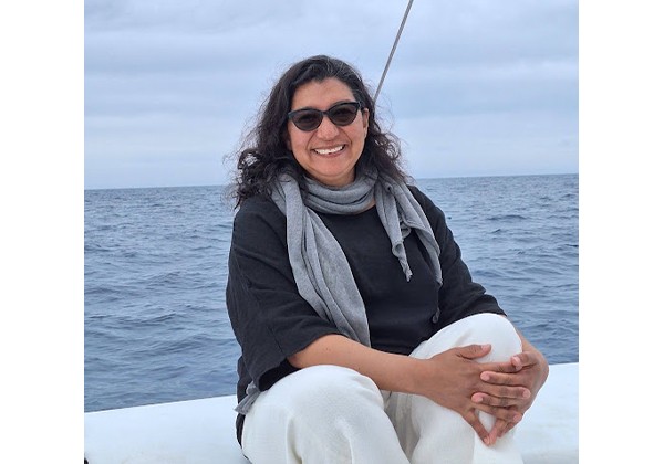 Maria wearing a black top sitting on a sail boat