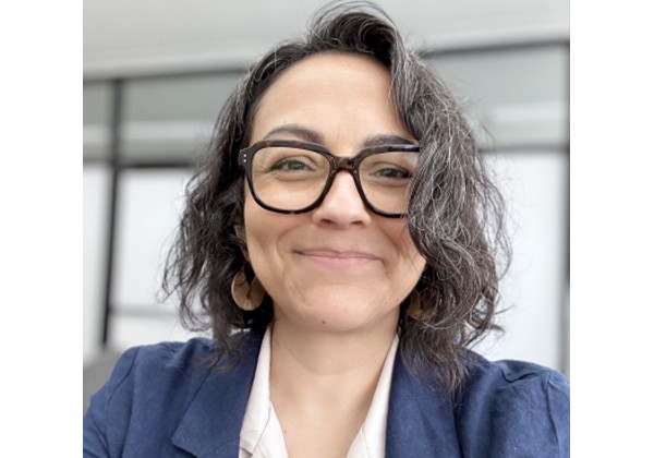 Susana Morales wearing glasses and a blue blazer