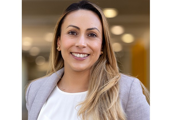 Professor Olaguez wearing a light grey blazer and a white top