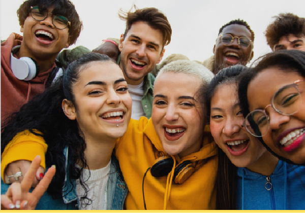 Smiling and laughing teens with arms around each other.