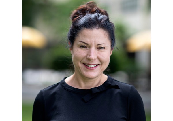 Professor Riggio wearing black top smiling