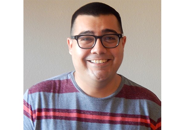Ryan Santos wearing a striped shirt with a cream background
