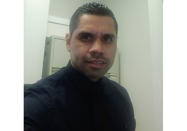 Professor Segura Lopez wearing a navy shirt