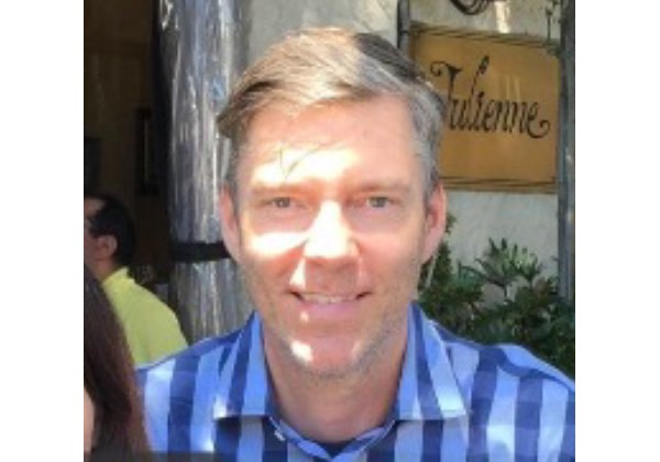 Professor Stenstrom with a checkered blue shirt smiling