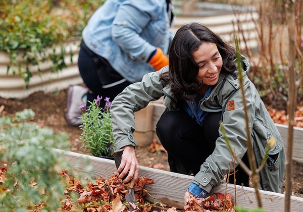 Smiling student planting