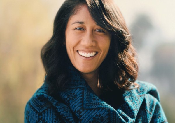 Woman smiling and wearing green clothing