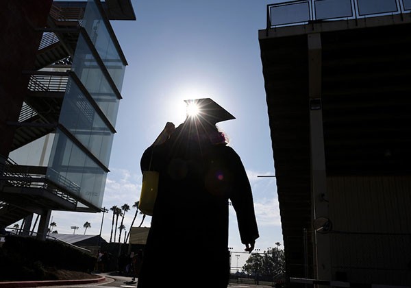 Shadow of a graduate on campus