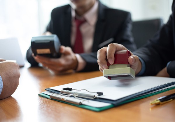 person stamping paperwork