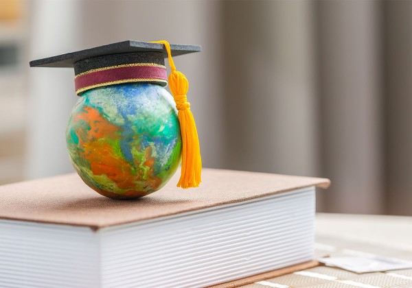 graduation cap on world globe