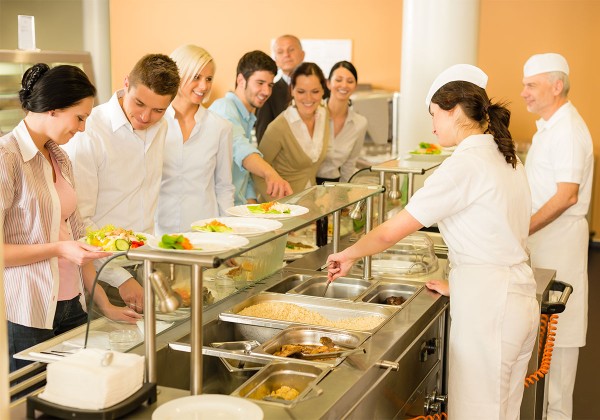 cafeteria workers serving food to people