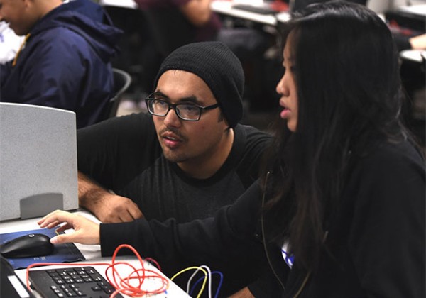 students working on computer engaged